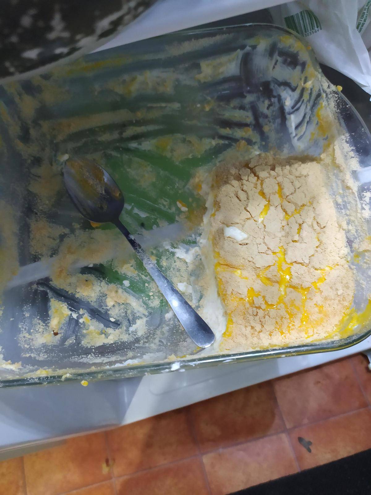 A pan of a yellow dessert that has been 3/4 eaten