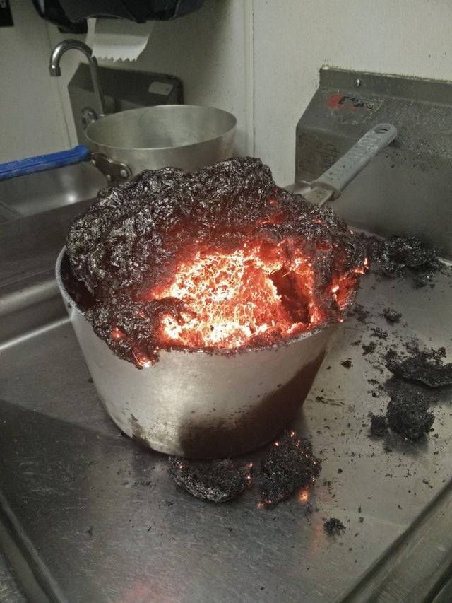 Pot of caramel that has overflowed and burned. 