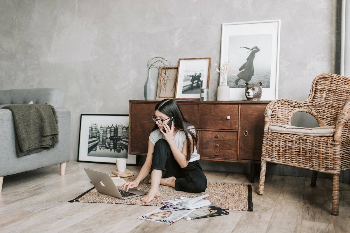Woman focused sitting on floor typing