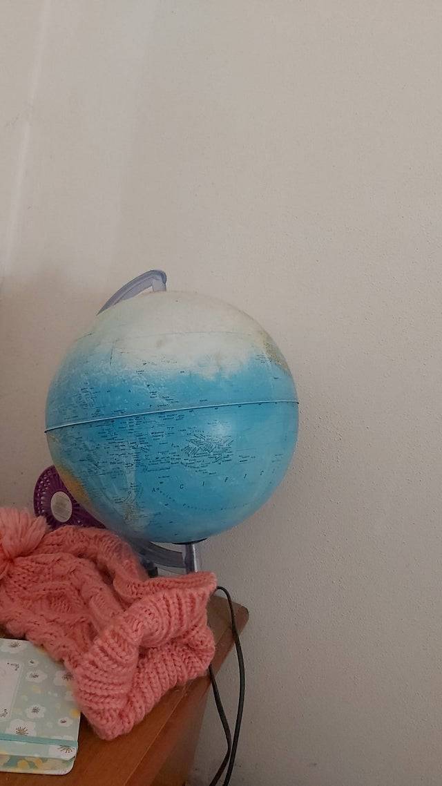 A globe that was cleaned and part of it was accidentally scrubbed off.