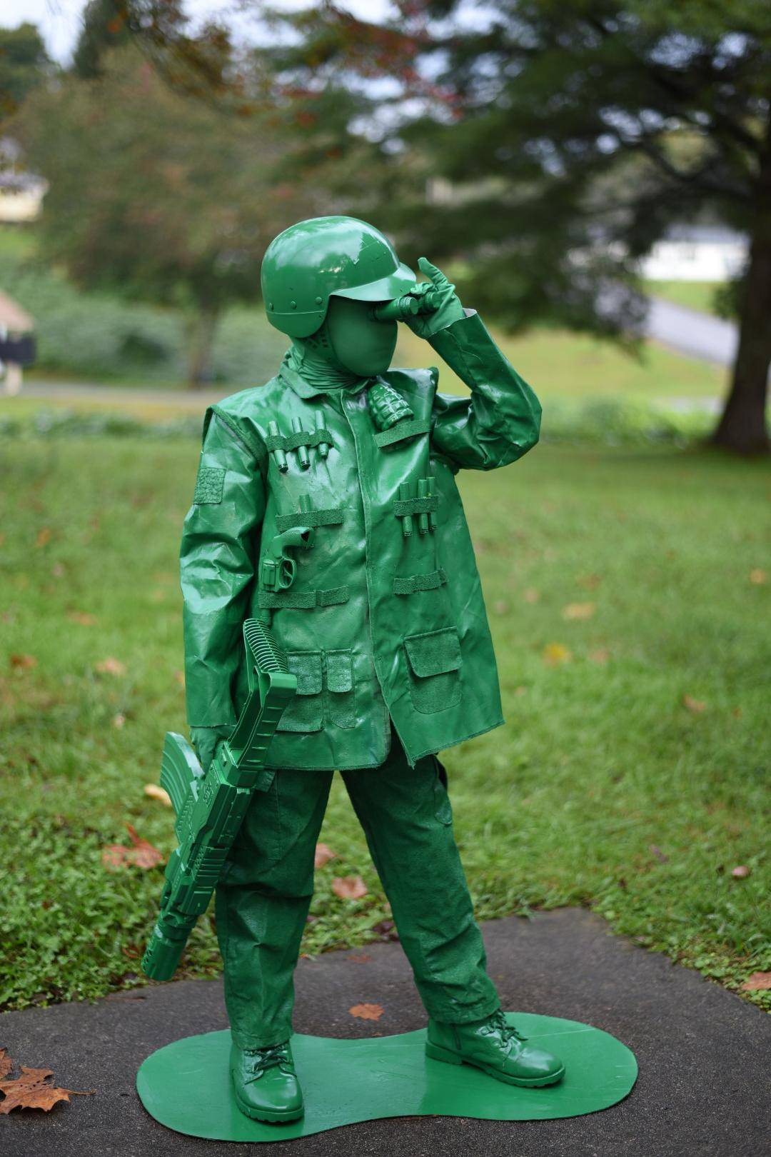 Young boy turned into a green army man with spray paint