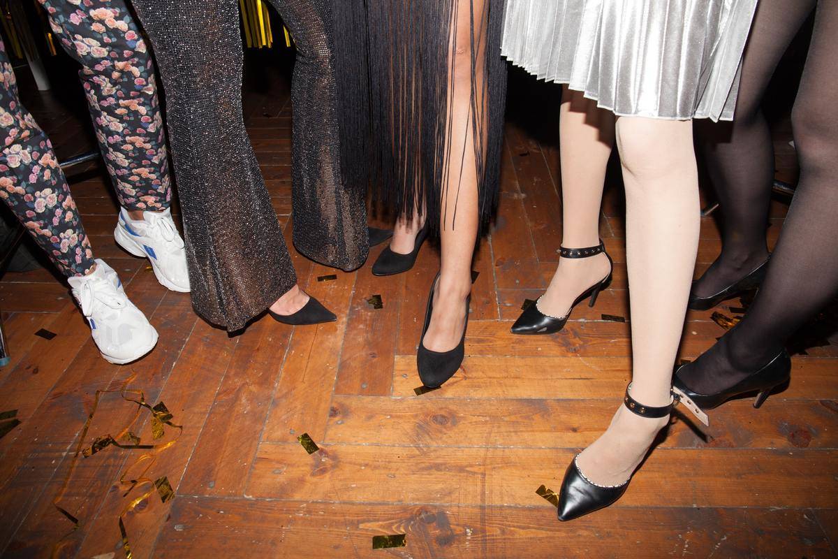 Women seen from the waist down in dresses and high heels