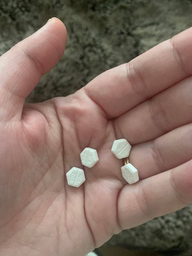 Hexagon shaped pills held in hand