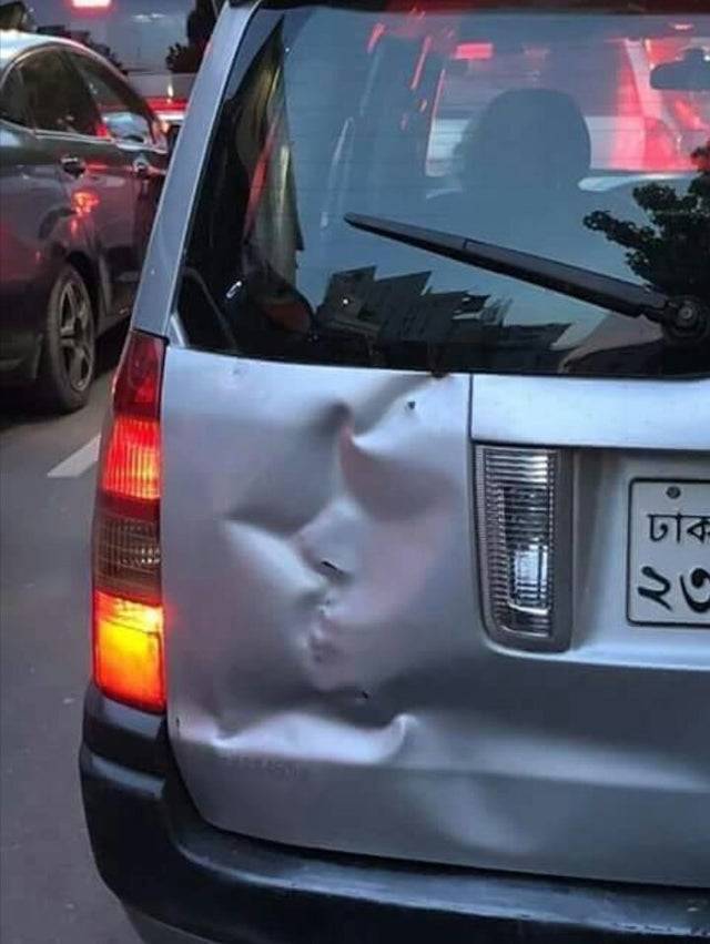 The smashed rear of a car looks like two people kissing. 