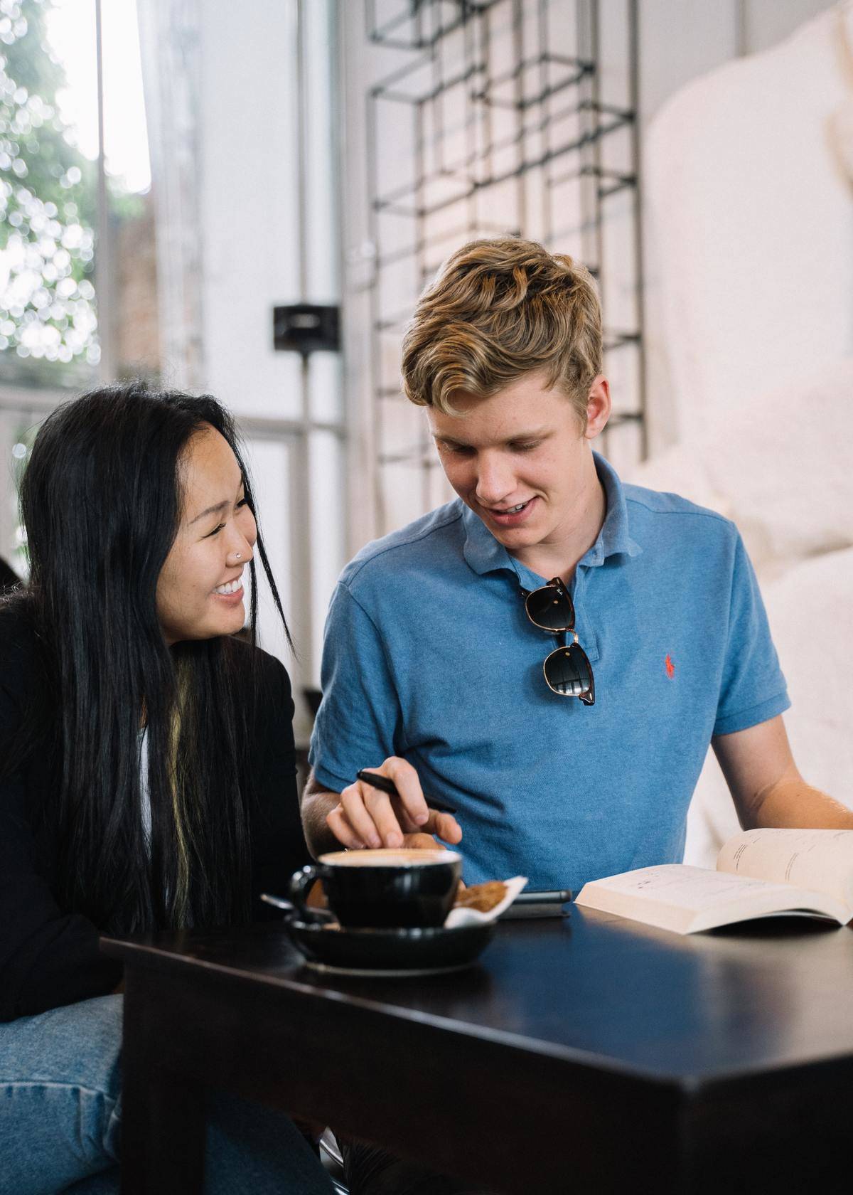 Woman laughing while talking to man in blue shirt