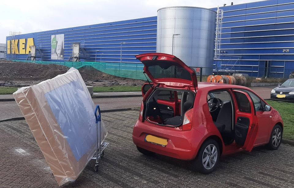 A large mattress and a small car. 