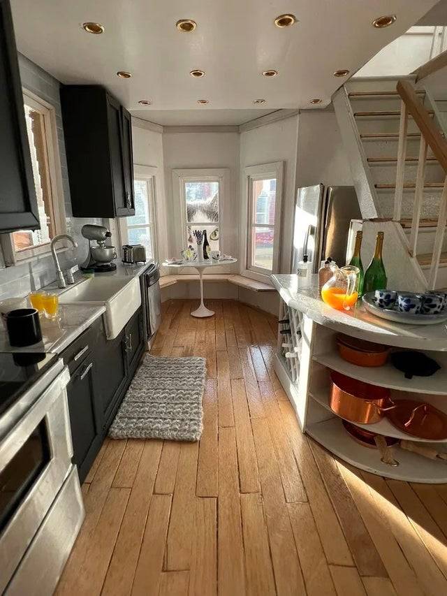 Inside of a house with a large cat looking in from the outside window. 
