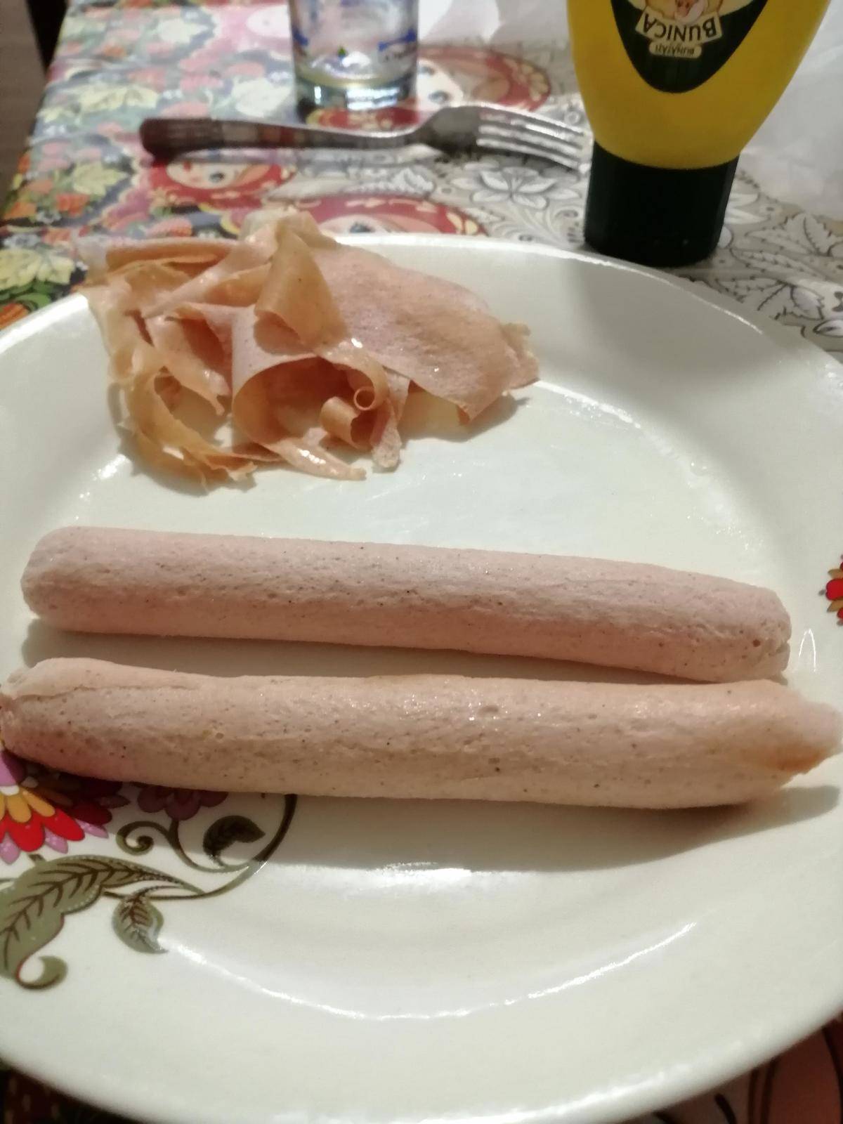 Two peeled hot dogs on a plate