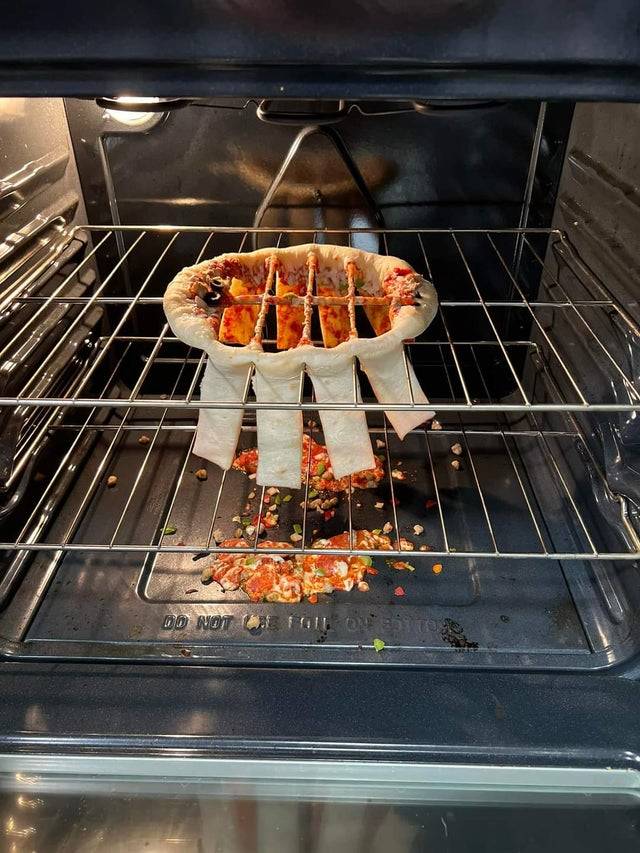 Frozen pizza falls apart in the oven because it's not on a baking pan. 