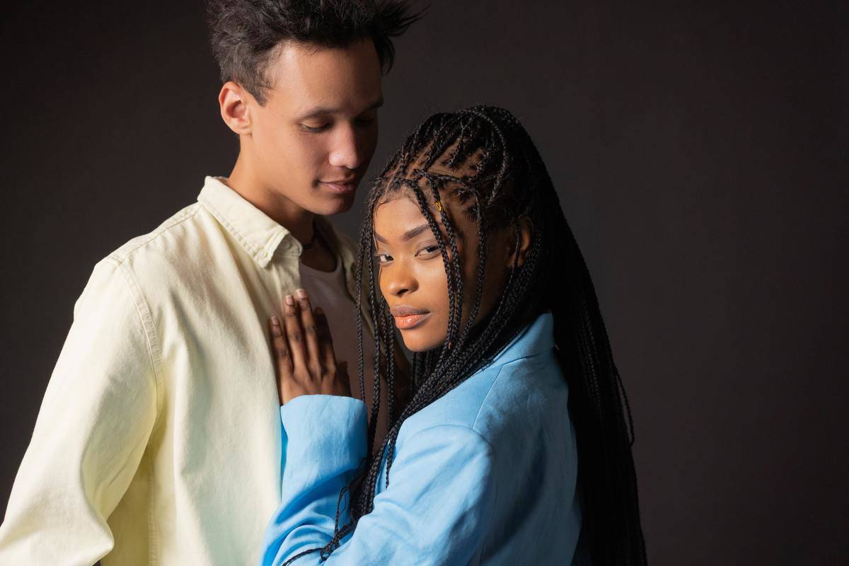 Woman with hand on man's chest 