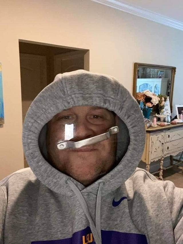 Man wearing pot inside hoodie as face shield 