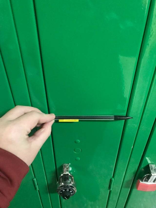 School locker smaller than pencil held by student