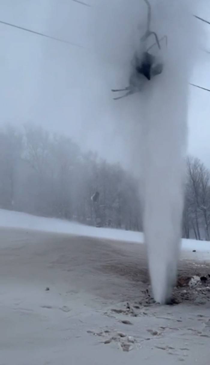 Skier gets stuck off ski-lift right above a burst water pipe.