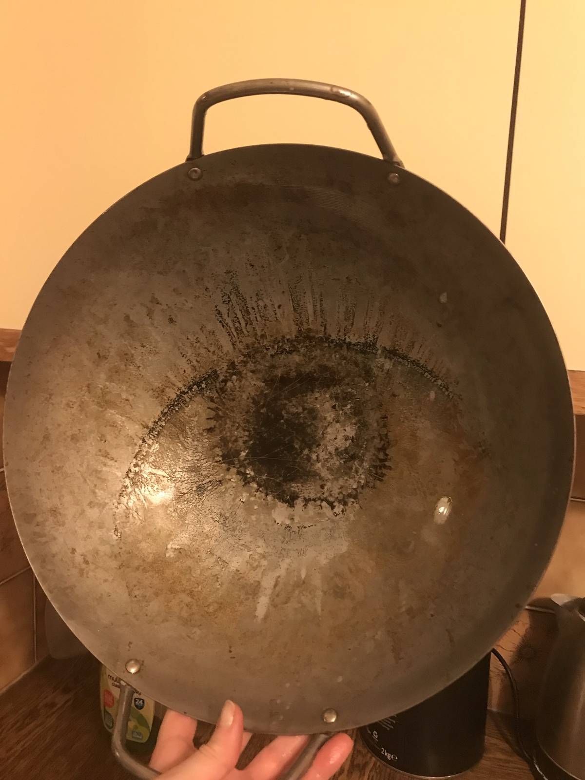 Wok with a stain in it that looks like a human eye. 