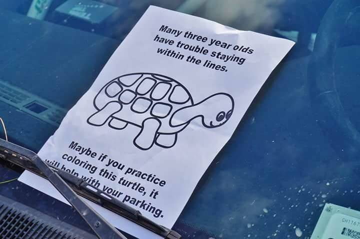 Note on windshield of car with the picture of a turtle on it.