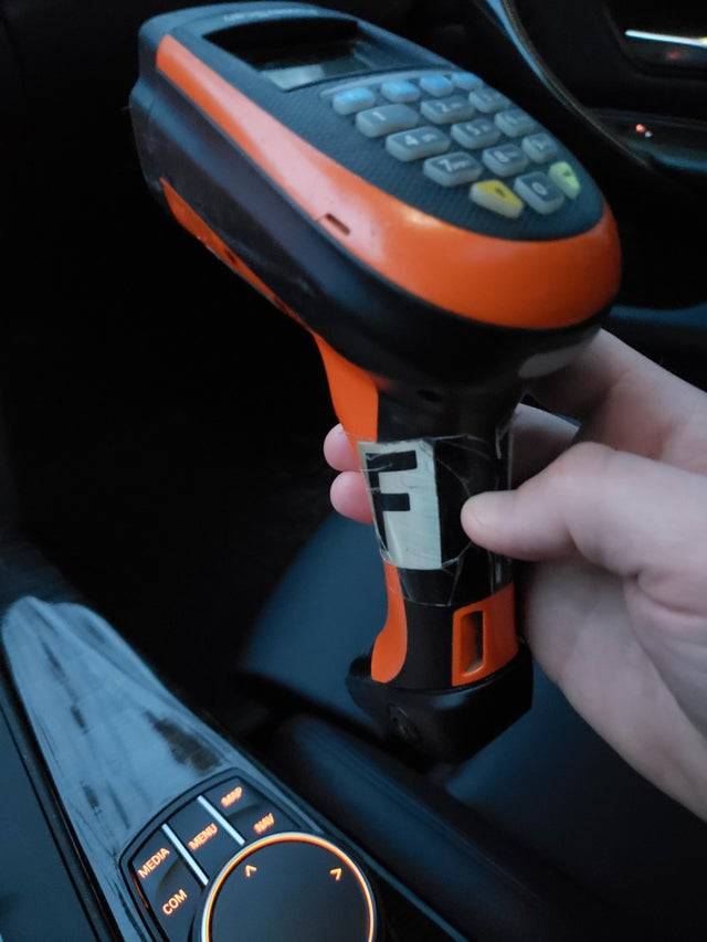 Hand holding a price scanner from a store