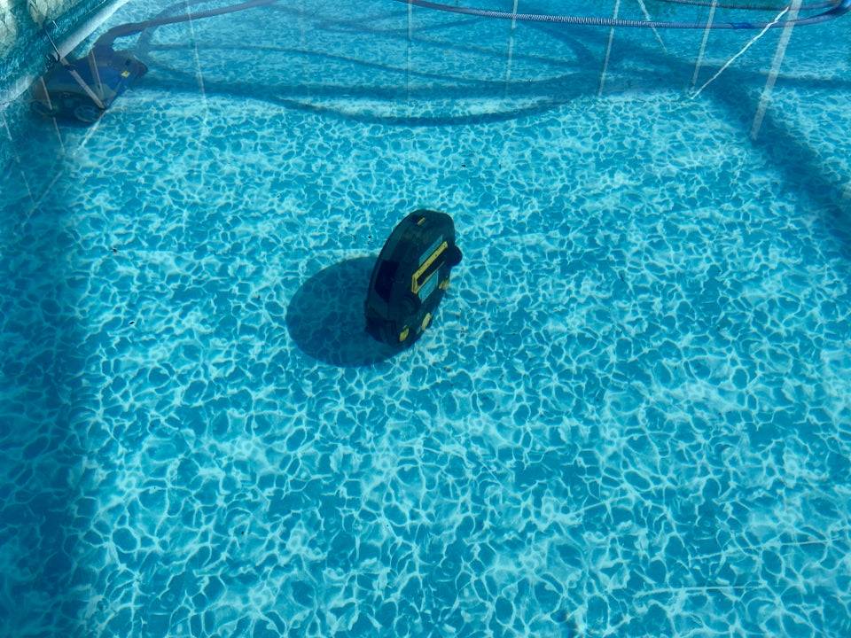 Robot house vacuum at the bottom of a pool. 