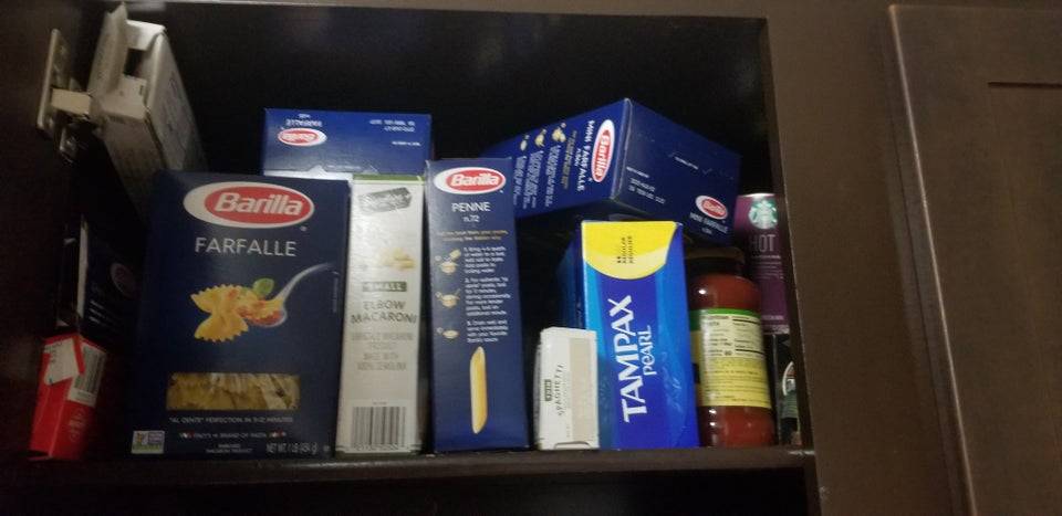 Box of Tampax put away with pasta boxes