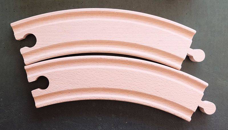 Wooden train tracks lined up against each other.