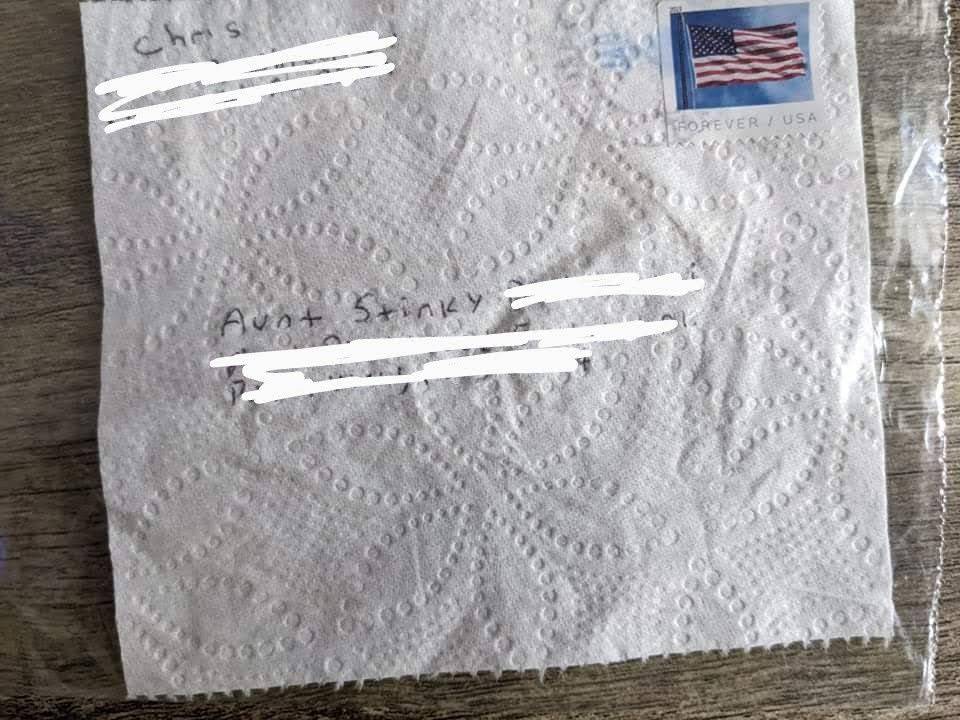 One single square of toilet paper with a mailing address and stamp