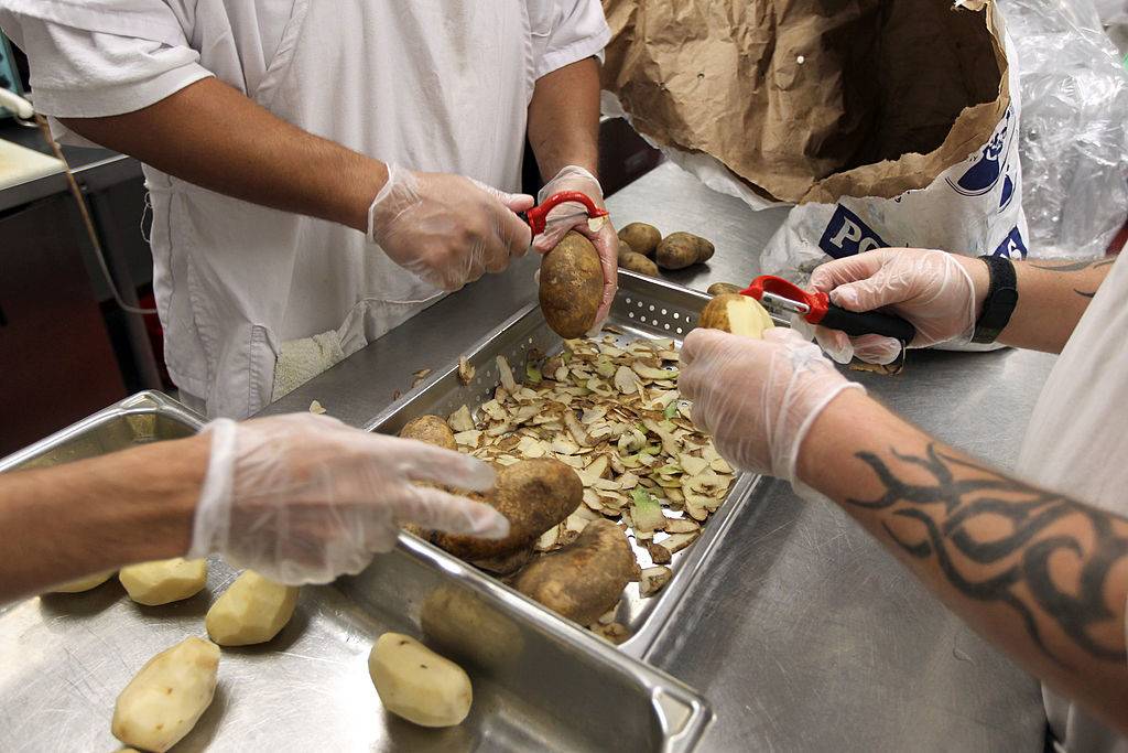men peeling potatoes