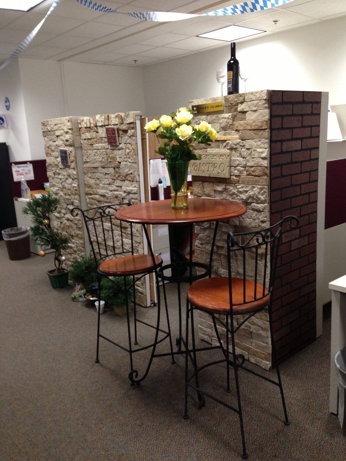 Cubicle with a fake bistro outside of it.