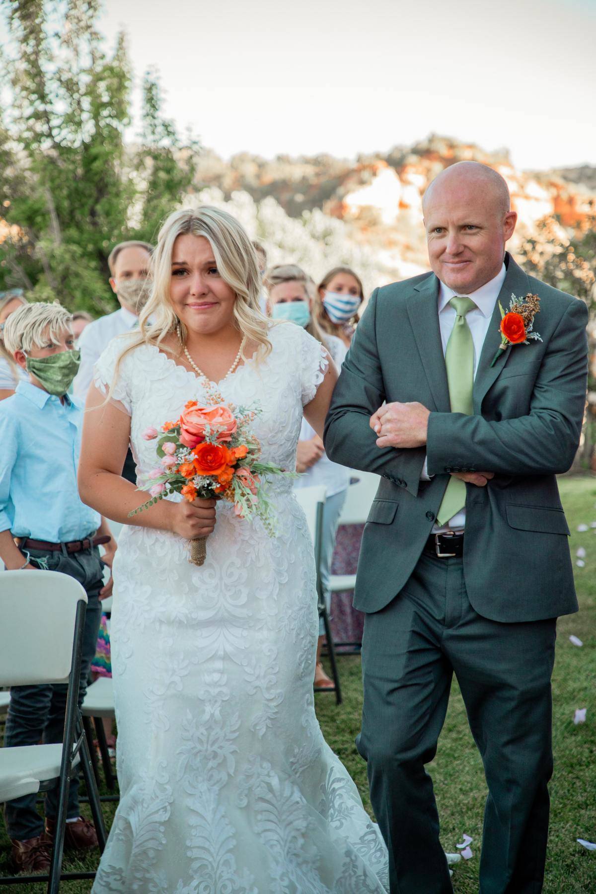 A father walks his daughter down the aisle on her wedding day.