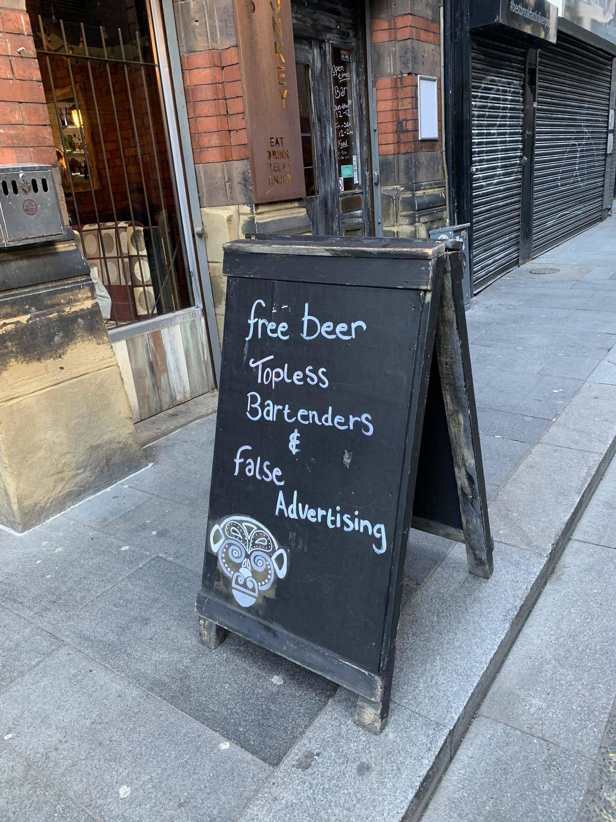 False advertising sign outside a restaurant on a chalk board