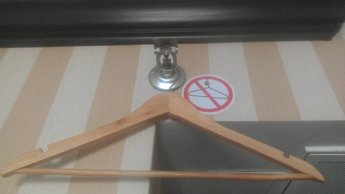 Coat hanger hanging from the sprinkler system