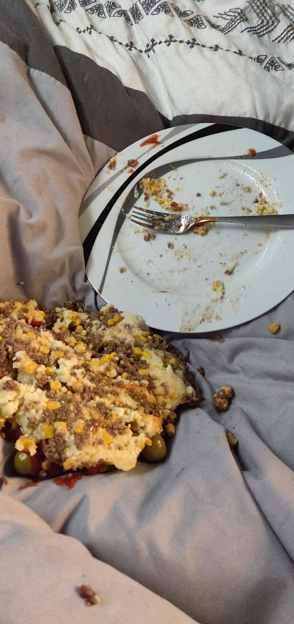 Food that's slid off of a plate in bed