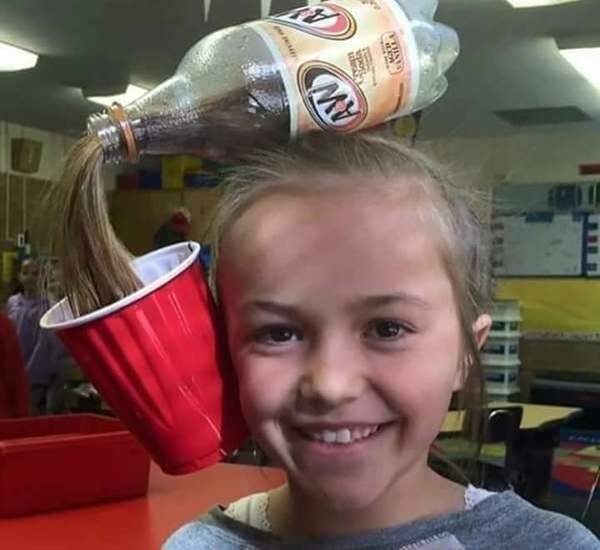 Girl with a pop bottle on her head
