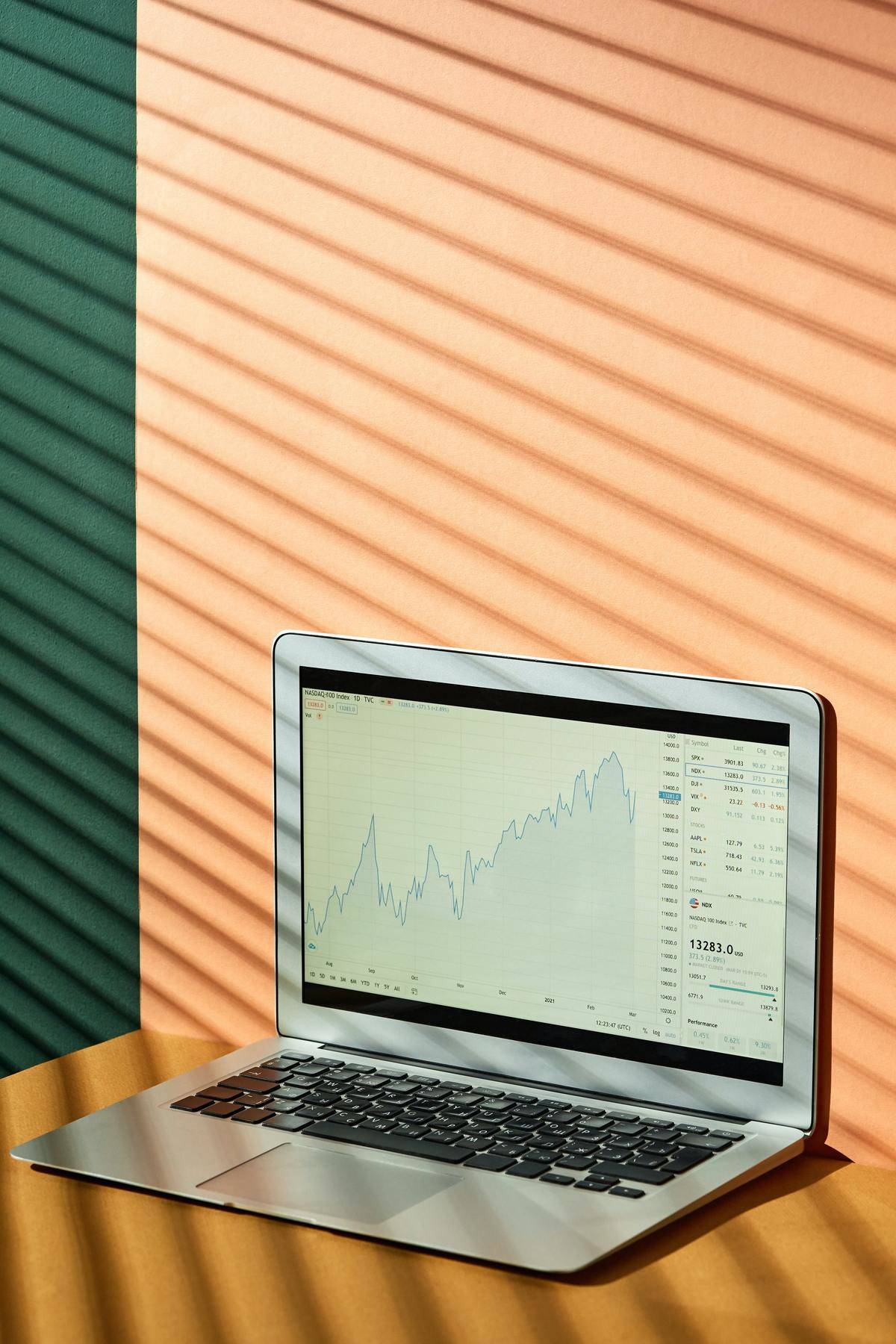 Laptop with stock market screen on it.