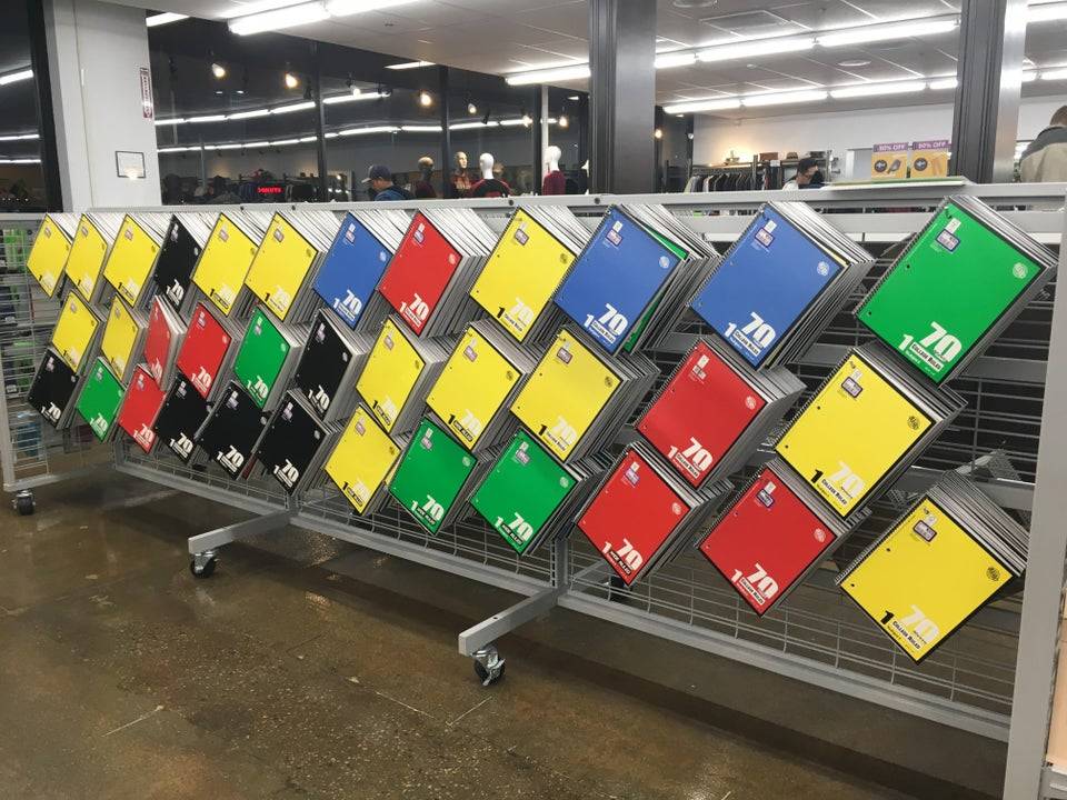 Different colored notebooks hung on a store shelf