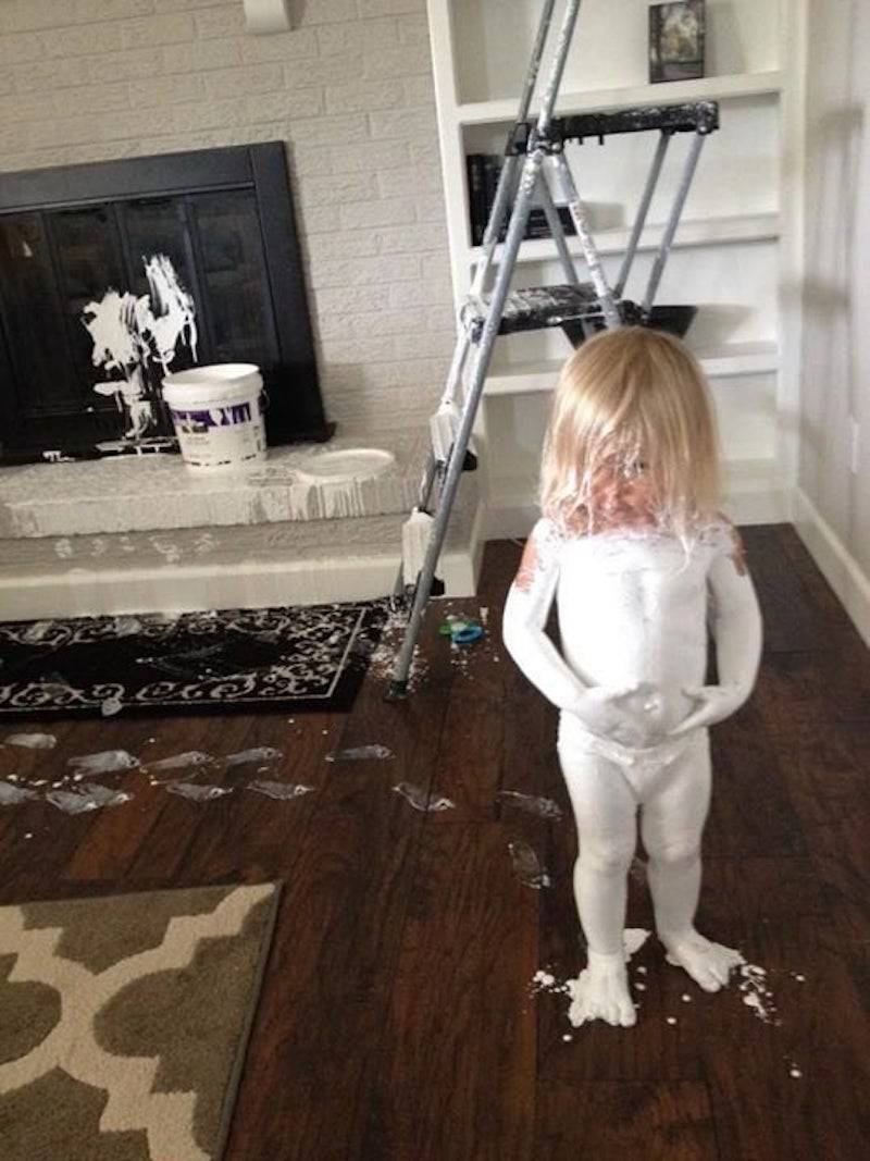Toddler covered in paint from living room