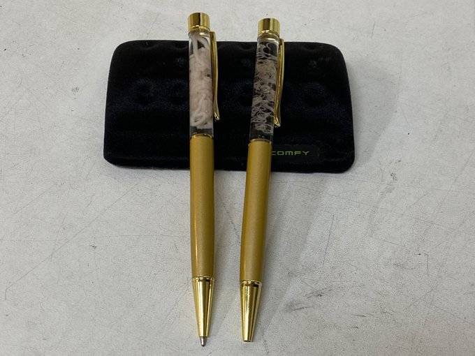 Two pens with a worm inside them.