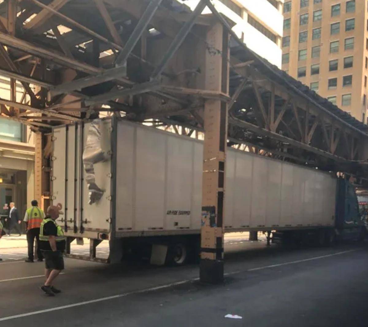 truck tries to go under bridge pass and sheers off top