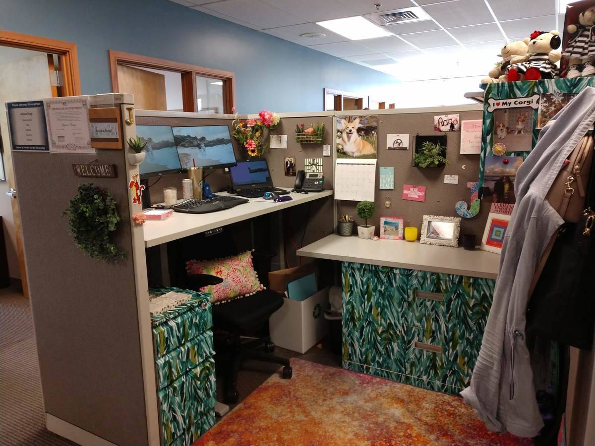 Cubicle decorated with sticky wallpaper.