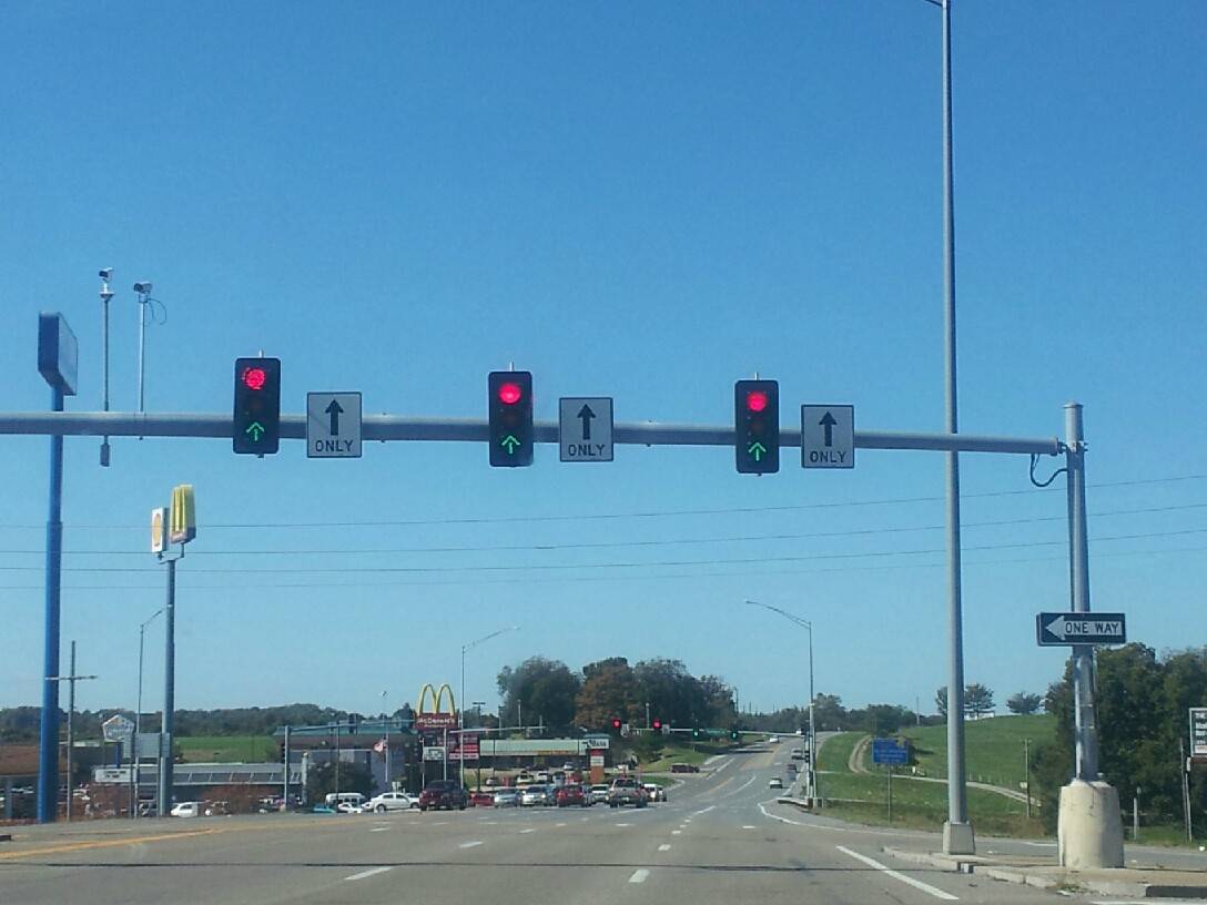 Traffic lights flashing red and green at the same time.