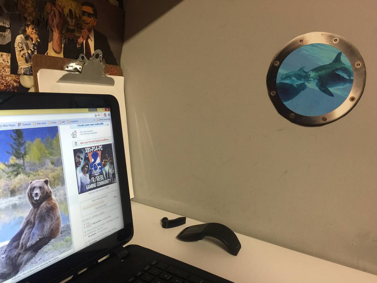 Cubicle with a submarine window on it.