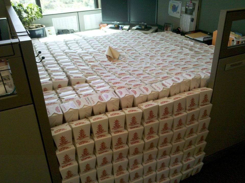 Cubicle filled with Chinese takeout boxes.