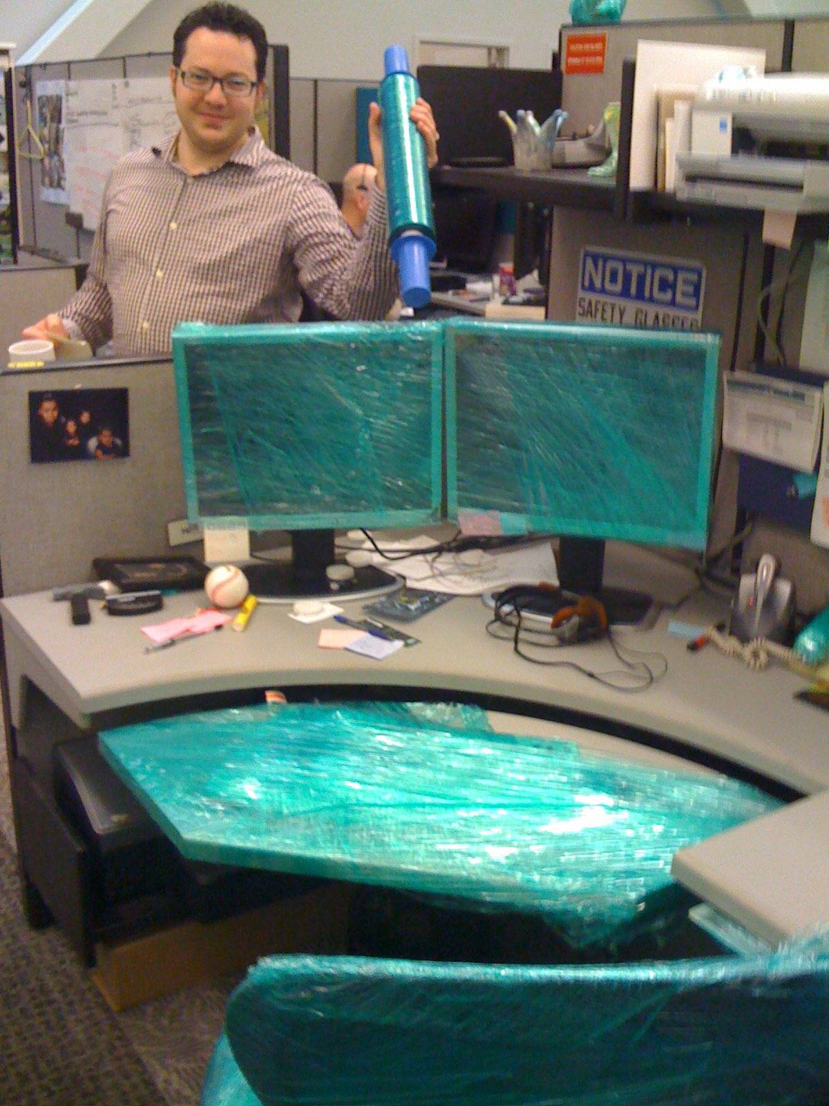 Cubicle desk covered in plastic wrap