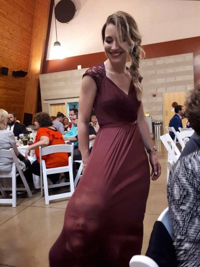 Toddler under bridesmaid dress