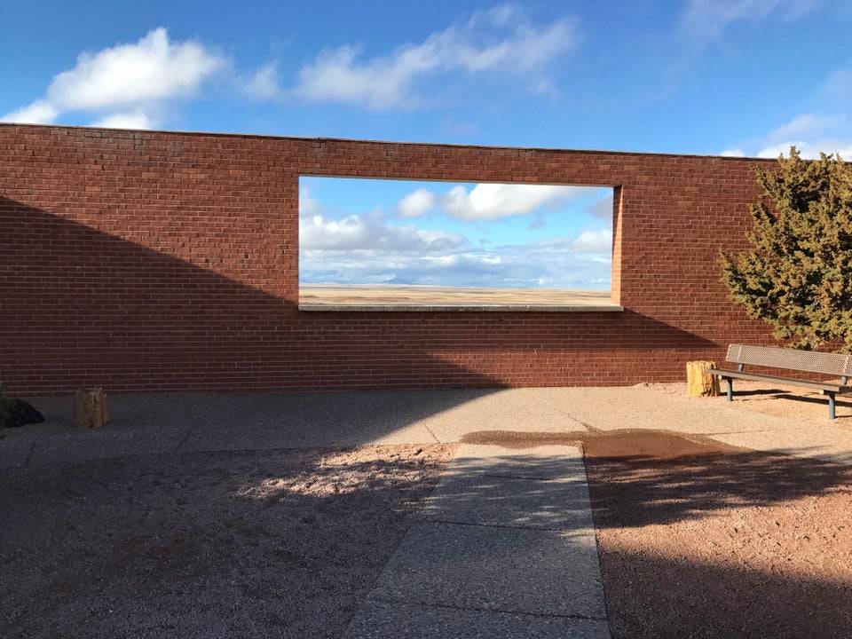 Hole in wall and blue cloudy sky behind it
