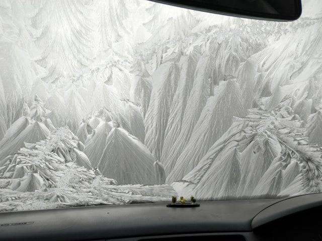 Windshield on vehicle frozen looks like scenic landscape