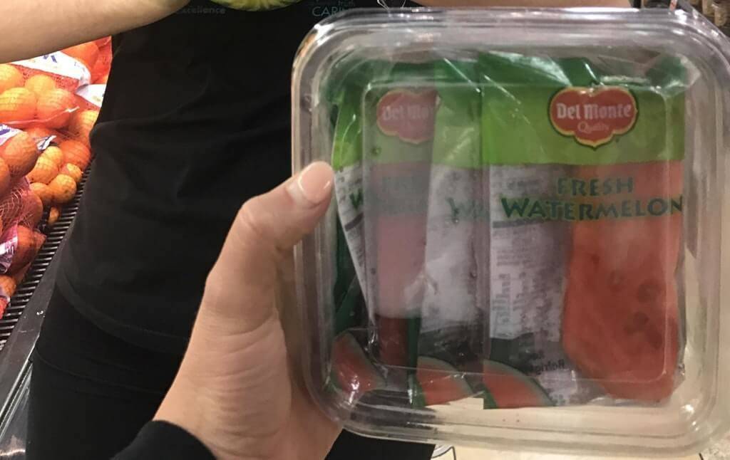 cut slices of watermelon plastic wrapped in tupperware container