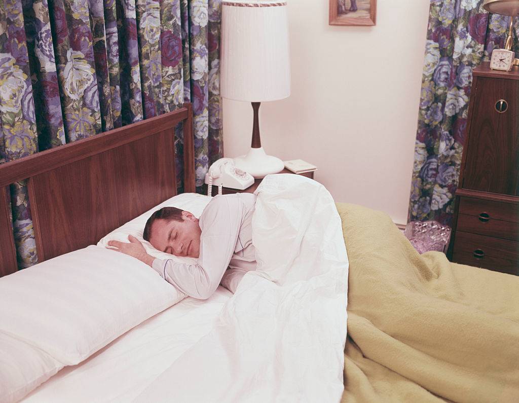 man sleeping in bed