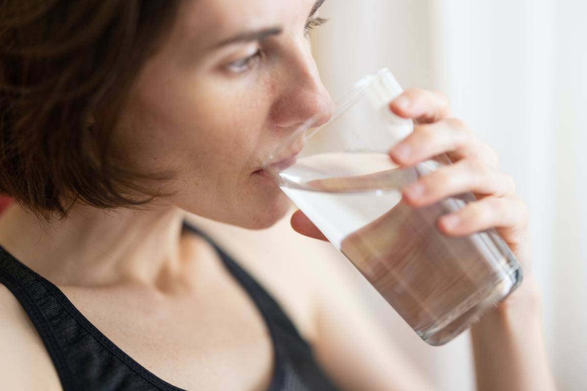 woman drinking a glass of water
