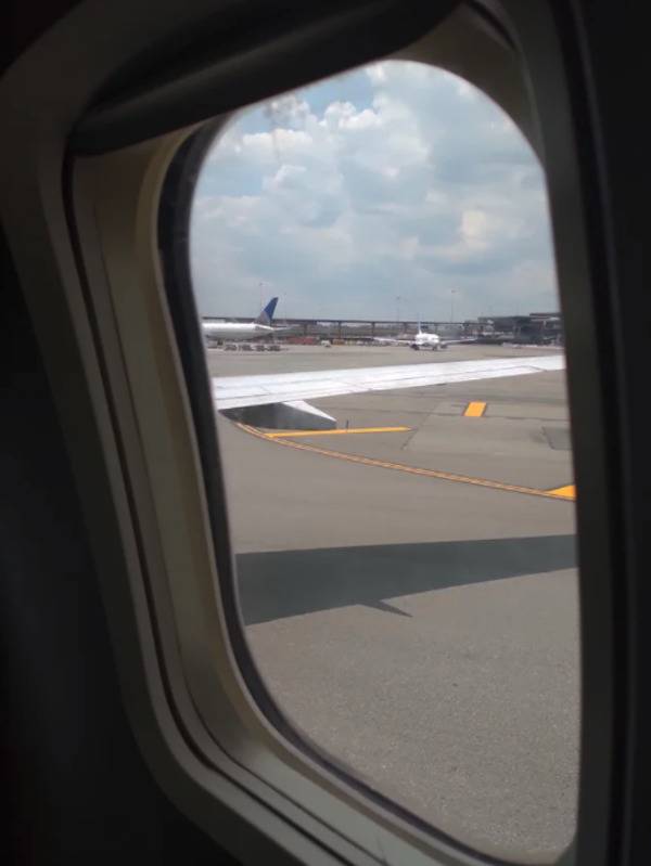 View looking out of an airplane on the tarmac.