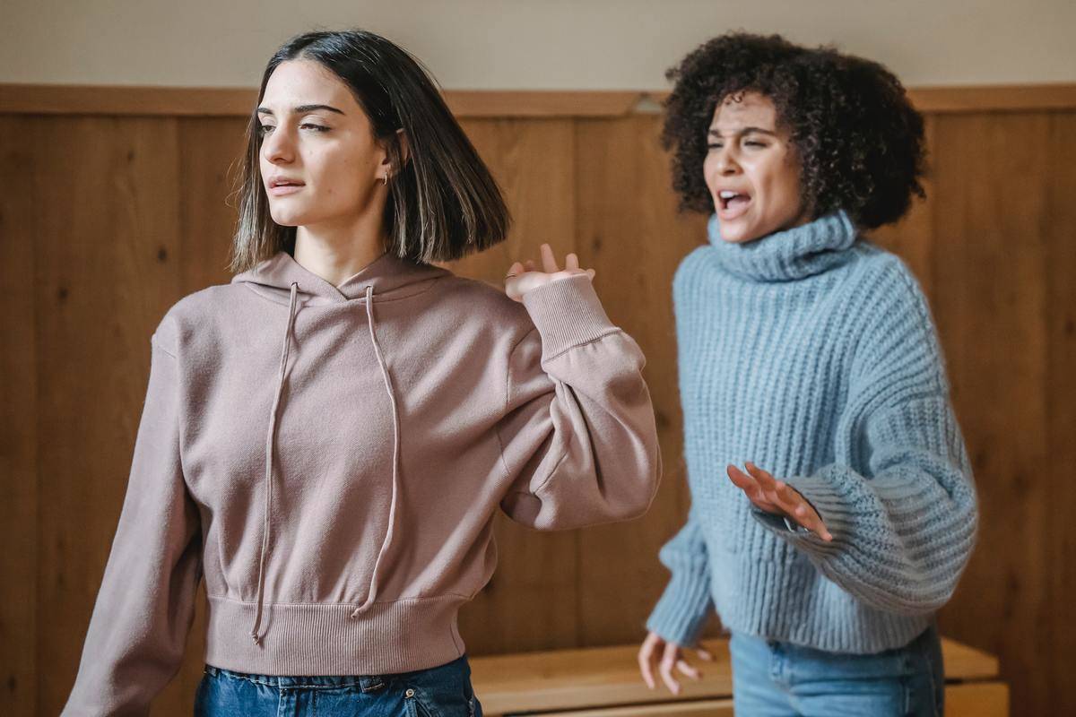 Two women argue with each other. 