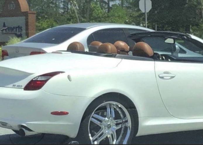White convertible car and a bald driver